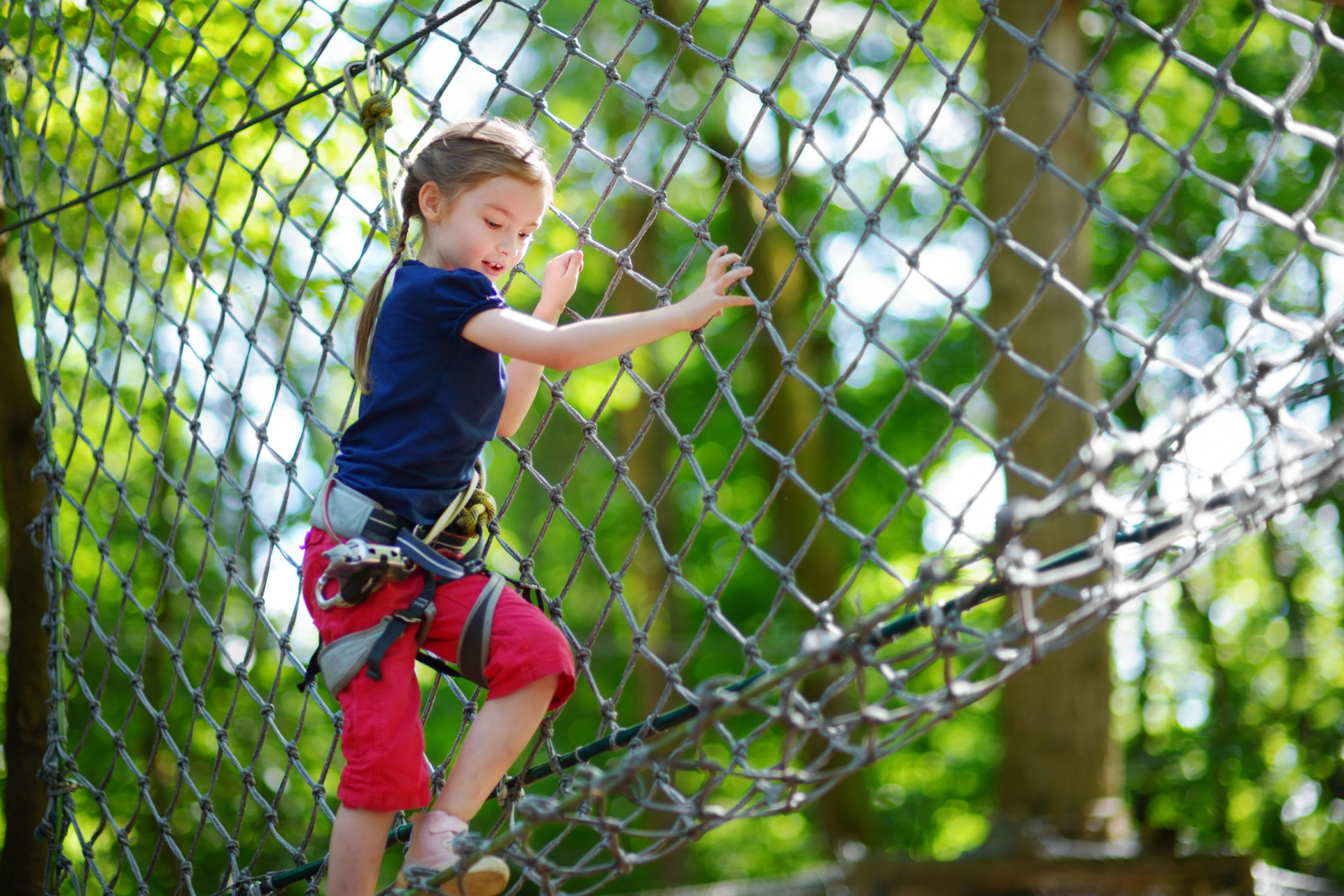 Girl climbs on obstacle at Treetop Adventure at Levi Jackson